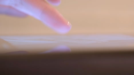 finger touching a tablet screen