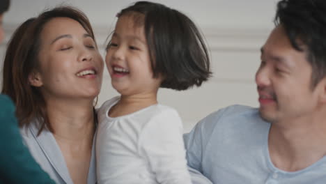 happy asian children jumping on bed little girl and her brother waking up mother and father enjoying playful morning with kids on weekend at home 4k footage