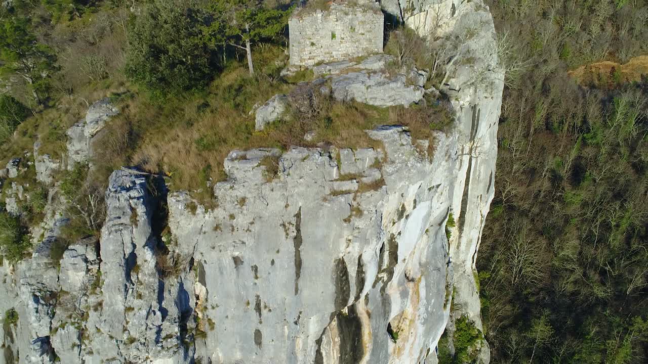 aerial view imposing cliff. Church and Christian cross, religion. Pedestal shot
