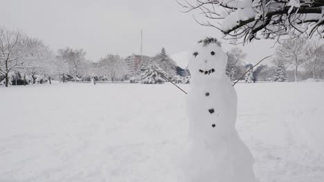 big snowman in the public park on a snowy day