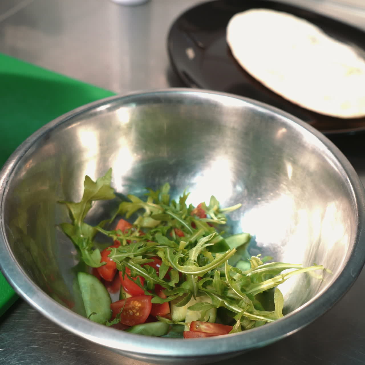 Chef cooking salad in a professional kitchen in a restaurant. Hands close up Sqare video