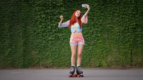 Woman on roller skates taking a selfie against an ivy wall