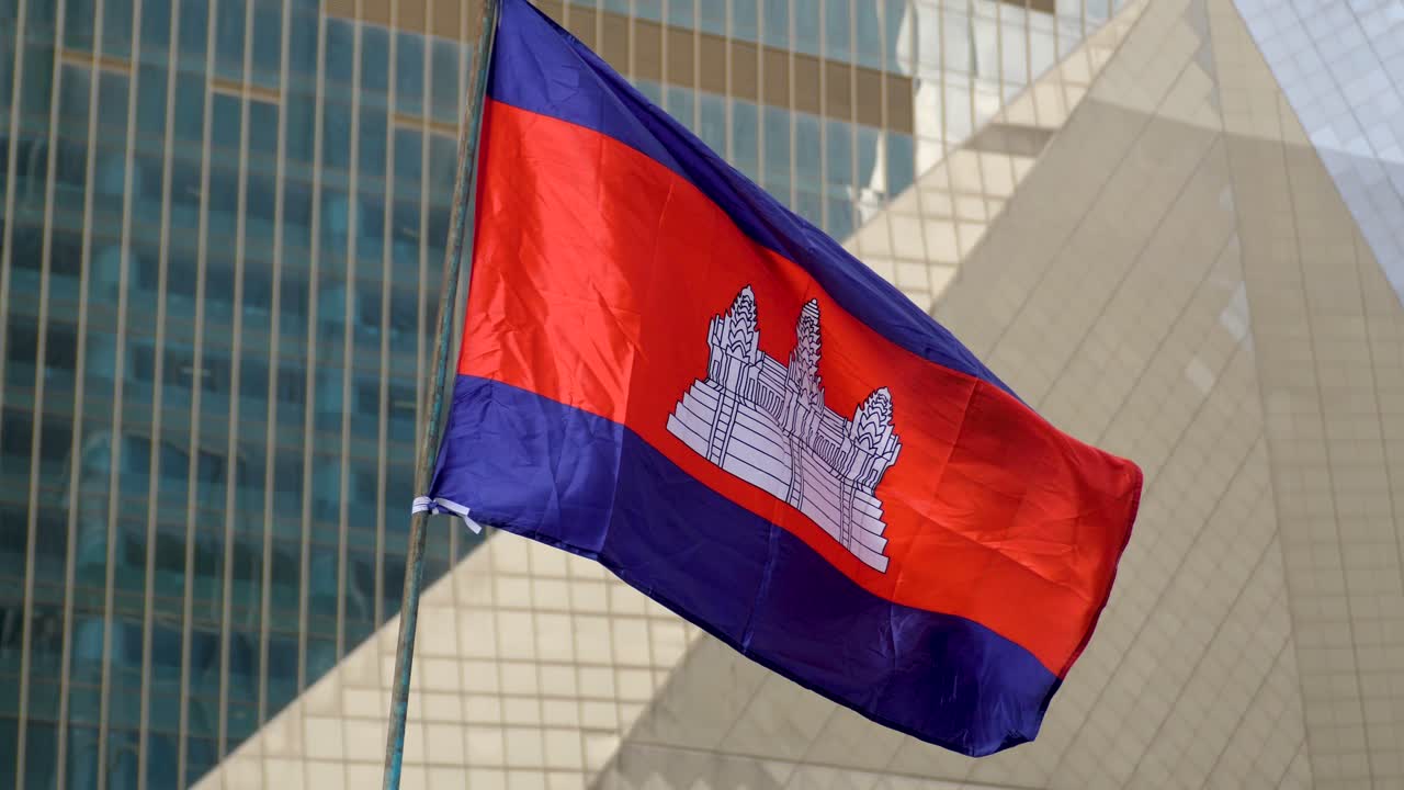 National flag of Cambodia features Angkor Wat temple flanked by two blue stripes central red stripe
