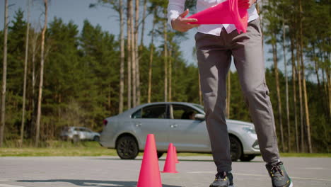 man placing traffic cones