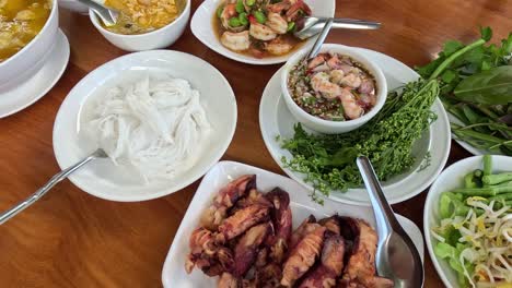 variety of thai dishes displayed on dining table.