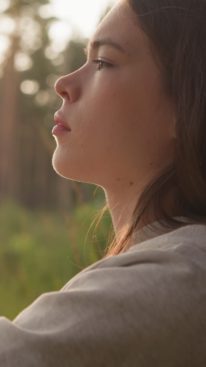 Sad lady rests leaning on tree trunk in forest. Distressed young woman reflects on idea of psychology help to cope with life challenges. Lady with closed eyes feels emptiness
