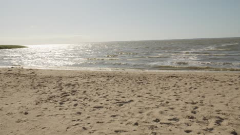 tranquil scenery of the beach at sunset in frombork, northern poland - panning shot