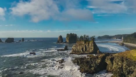 a breathtaking vista of a rugged coastline featuring dramatic rock formations, crashing waves, and lush green forest. drone view.