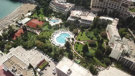 drone fly above luxury swimming pool resort , bečići town in the municipality of budva, montenegro adriatic sea