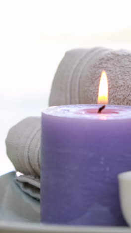 beauty treatment in bowl presented on plate with candle