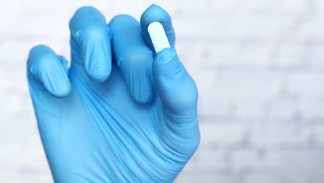 medical professional holding a pill