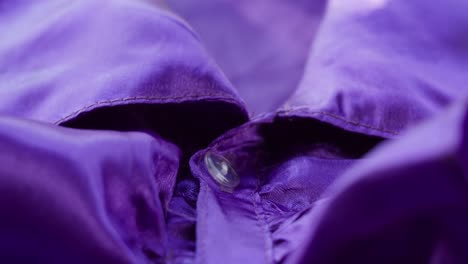 purple ruffles, collar close-up. sewing a violet dress. handmade tailoring, professional clothing concept. abstract background