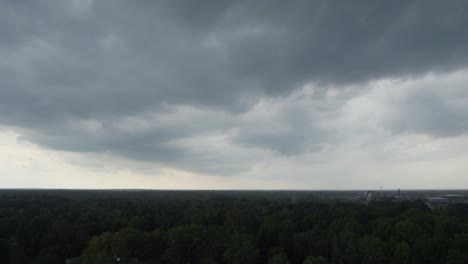 a drone shot of stormy sky with dramatic clouds from an approaching thunderstorm at sunset