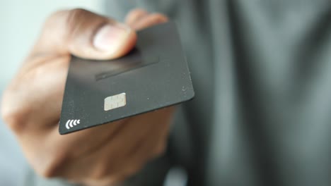 person holding a black credit card