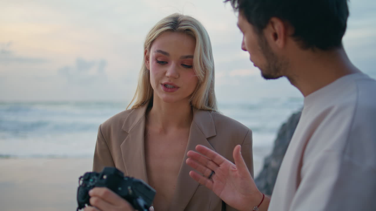 modelo de fotografía discutiendo imágenes en el cielo del océanos al atardecer. equipo de moda de primer plano