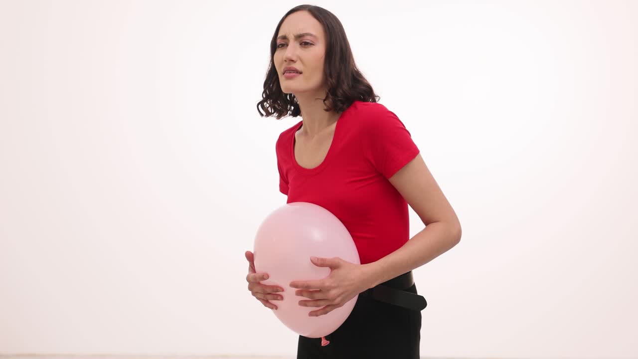 Woman Pretending to be Pregnant with Pink Balloon