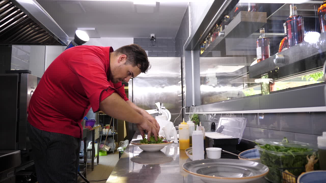 Chef preparing salad in commercial kitchen