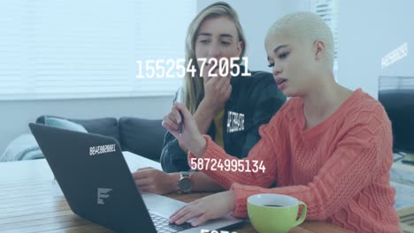Animation-of-data-processing-over-diverse-female-couple-using-laptop