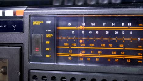 tuning analog radio dial frequency on scale of the vintage receiver