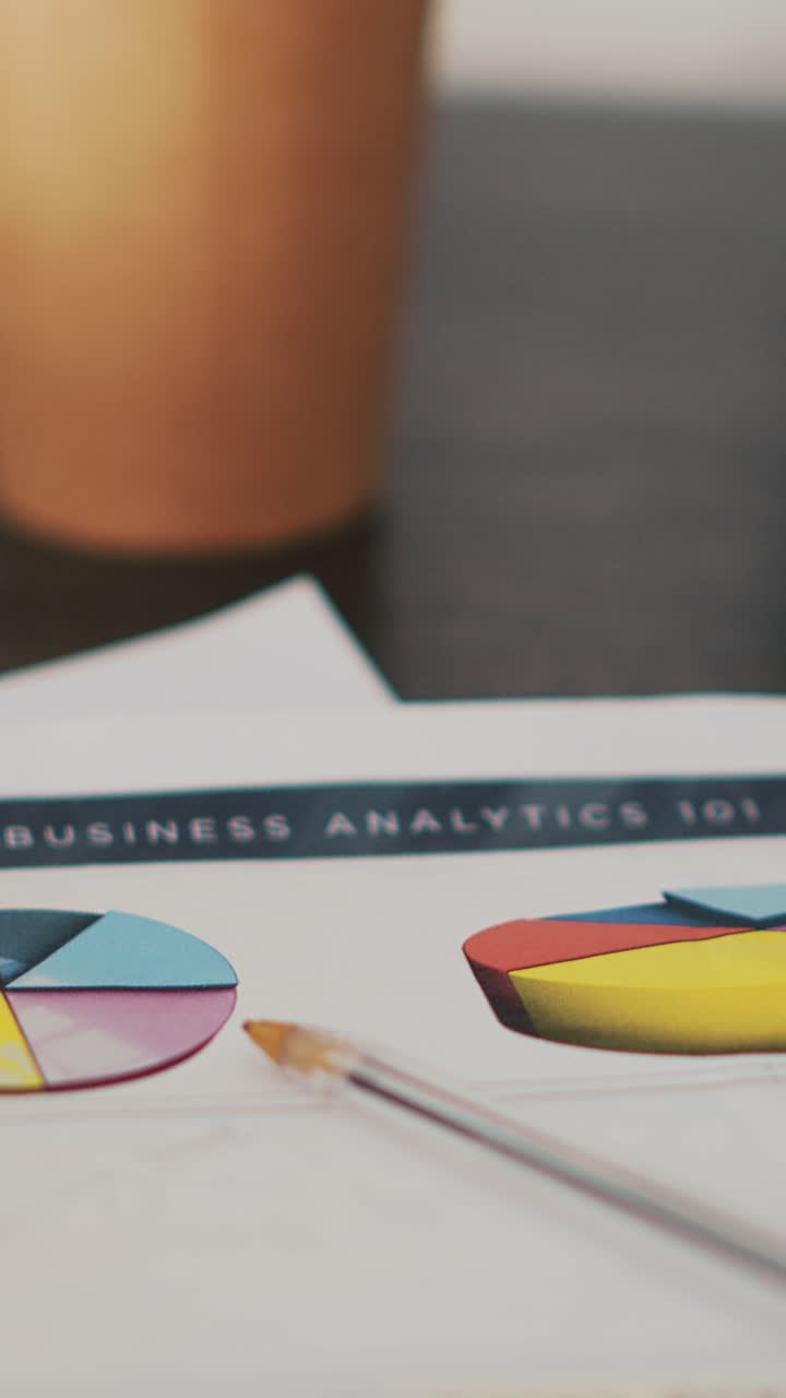 Vertical video Paperwork on office desk containing business financial information, close up