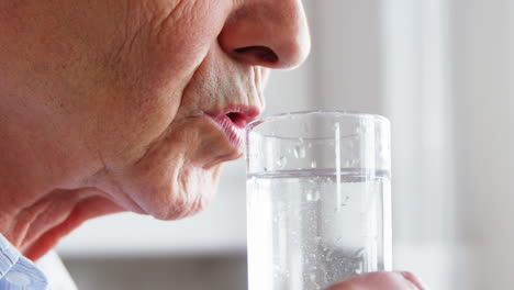 senior man drinking a water glass