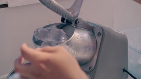 barman prepares ice in the machine for making ice