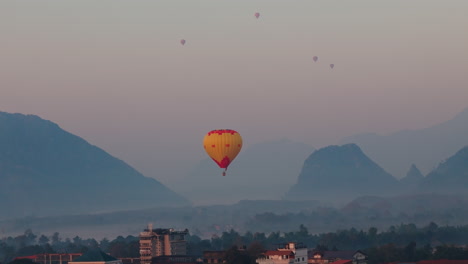 hot air balloon over misty mountains