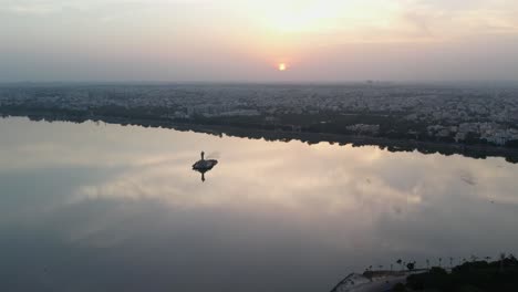 a beautiful sunrise over the indian city of hyderabad cinematic footage of hyderabad's most famous area, hussain sagar lake