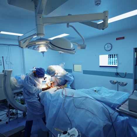 group of doctors perform an operation to a patient. surgeons in medical uniform and masks working in the operating room. neurosurgery