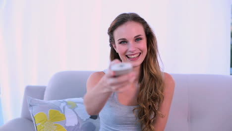 Smiling-model-watching-tv-on-the-couch