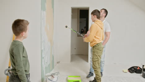 father and son painting a room