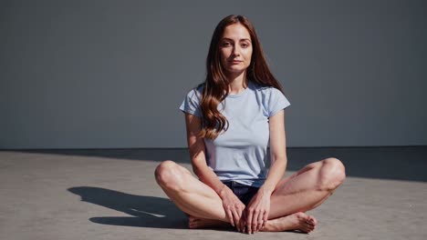 serene woman meditating indoors, cultivating tranquility through a simple pose, embracing mindfulness and self care while fostering balance and harmony in her life