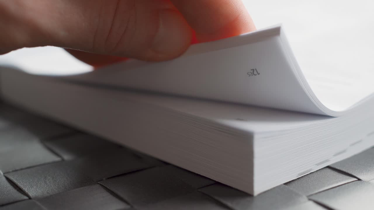 Man skimming through the pages of a user manual