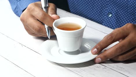 person holding a cup of tea