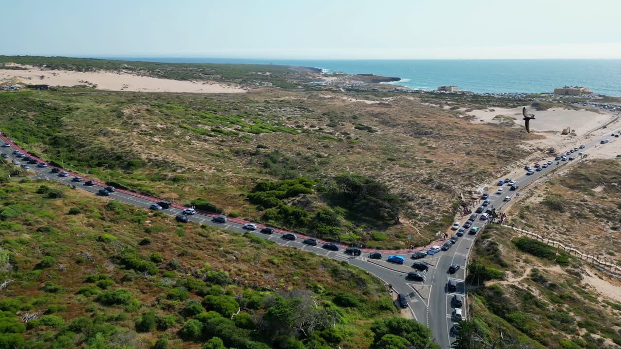 Circular aerial view of the Guincho road and beach,with a intense long lines,due to a great day with good weather for the beach causing many people to go, and cause congesting traffic.Cascais,Portugal
