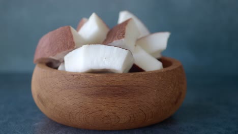 fresh chopped coconut in a wooden bowl