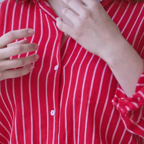 woman hands buttoning shirt