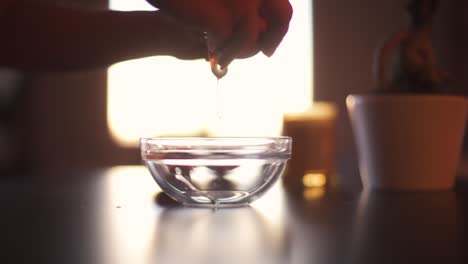 Egg-cracked-open-in-a-glass-bowl-before-breakfast