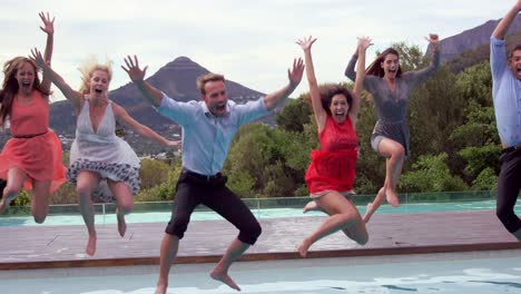 group of friends jumping in swimming pool