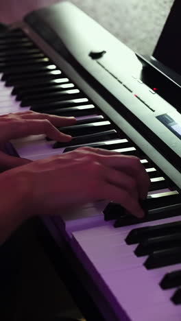 person playing a digital piano