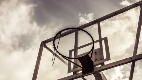 dramatically moving cloud background of a basketball ring in warm color