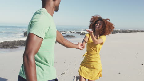 african american woman invites her husband to following her seaside