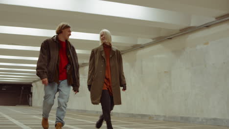 young couple walking in underpass