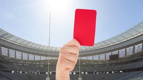 animación del árbitro que sostiene la tarjeta roja en el campo de rugby en el estadio deportivo