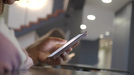 woman using a smartphone in a cafe