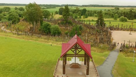 an aerial shot ascending over the hill of crosses, lithuania