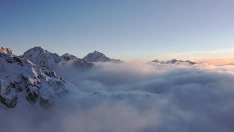 mount siguniang - mountain of the four maidens on a foggy sunrise in sichuan, western china