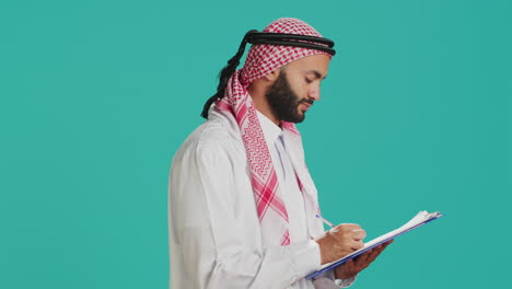 Arab-man-writing-letter-on-papers