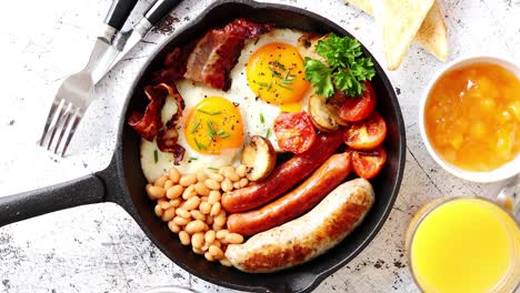 delicious english breakfast in iron cooking pan