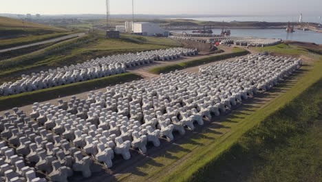 Aerial-view-of-a-stockpile-of-concrete-wave-breakers-outside-a-manufacturing-plant,-Aberdeenshire,-Scotland